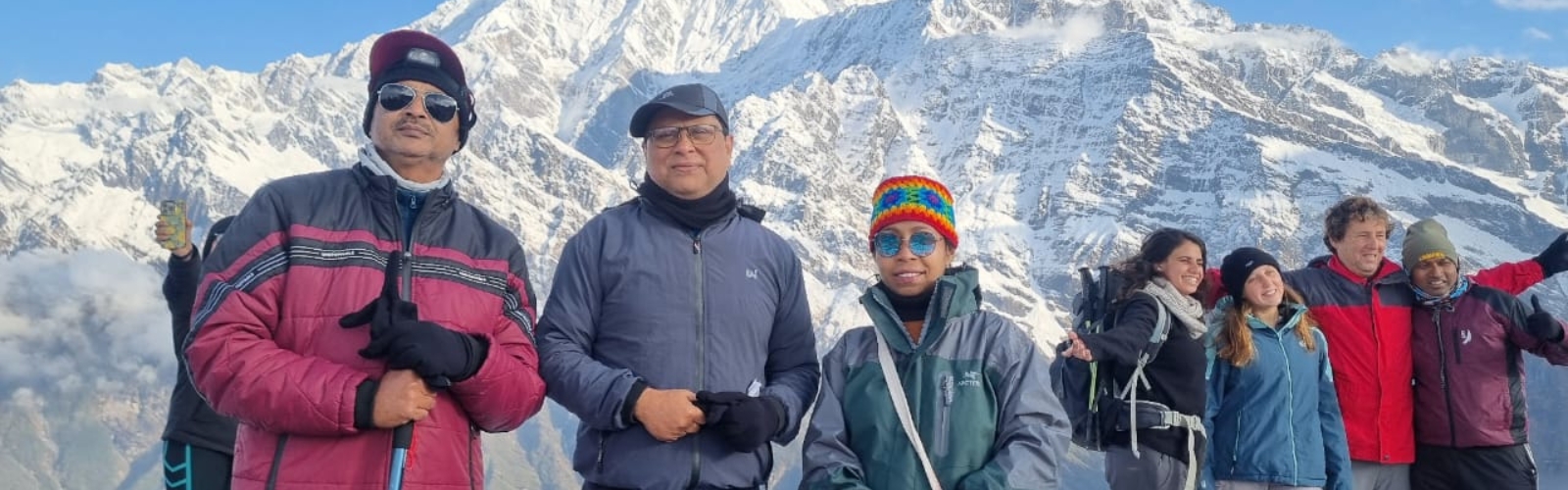 Corporate group enjoying scenic mountain peaks during trek
